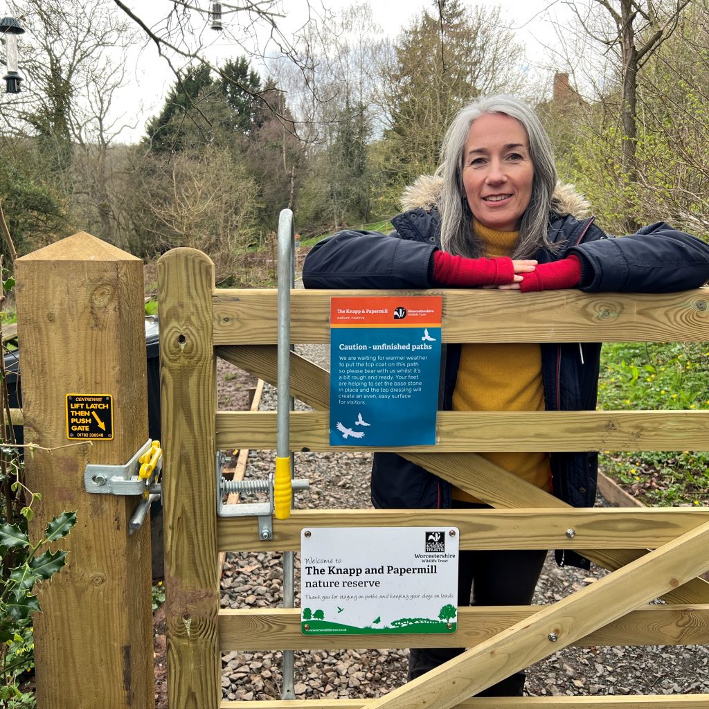 Lady leaning on disabled access gate