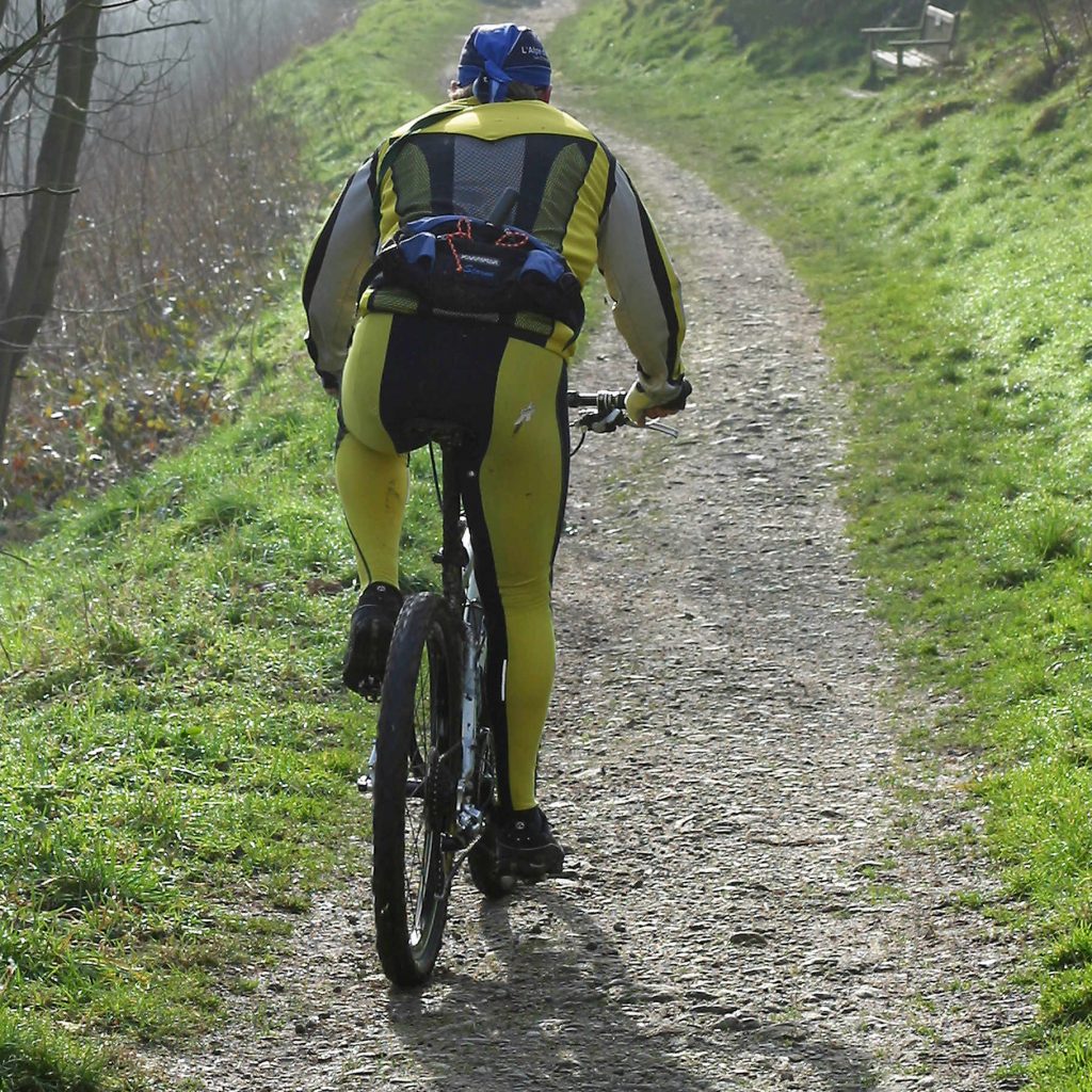 Mountain Biker travels along bridleway